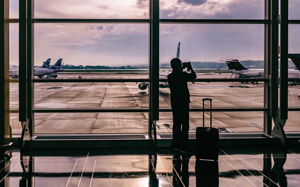 Man taking photo of planes at airport