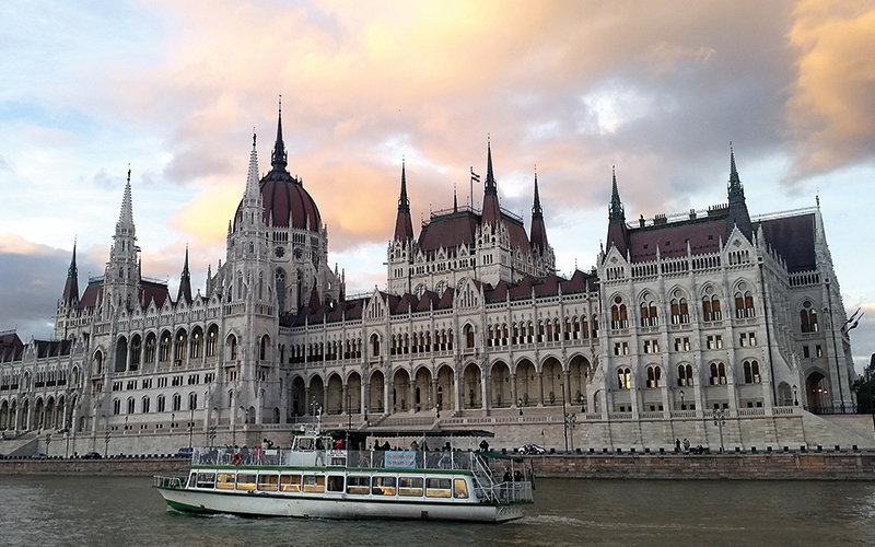 Budapest river with a boat cruising on it