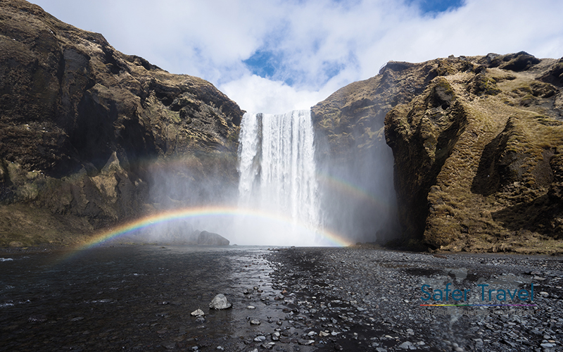 Rainbow across waterfall